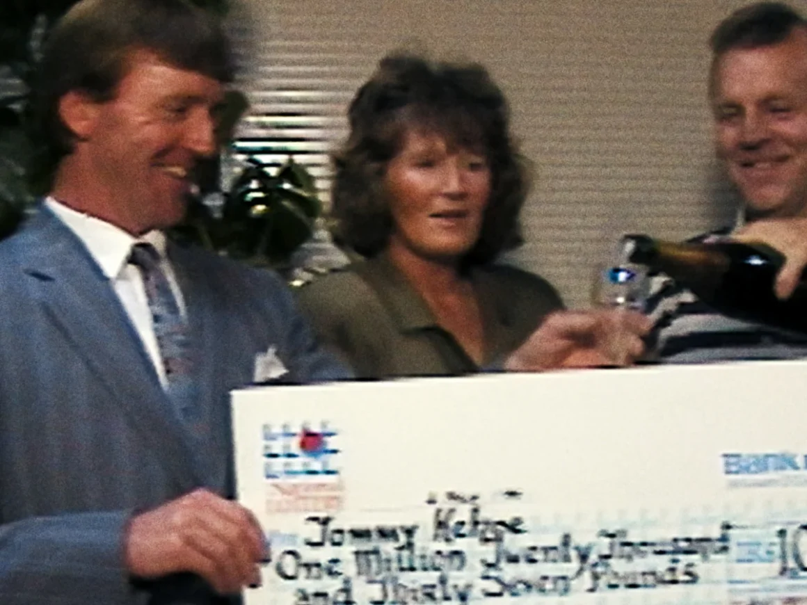 Still from the Irish documentary film Beat the Lotto showing 1997 winners with their giant cheque.